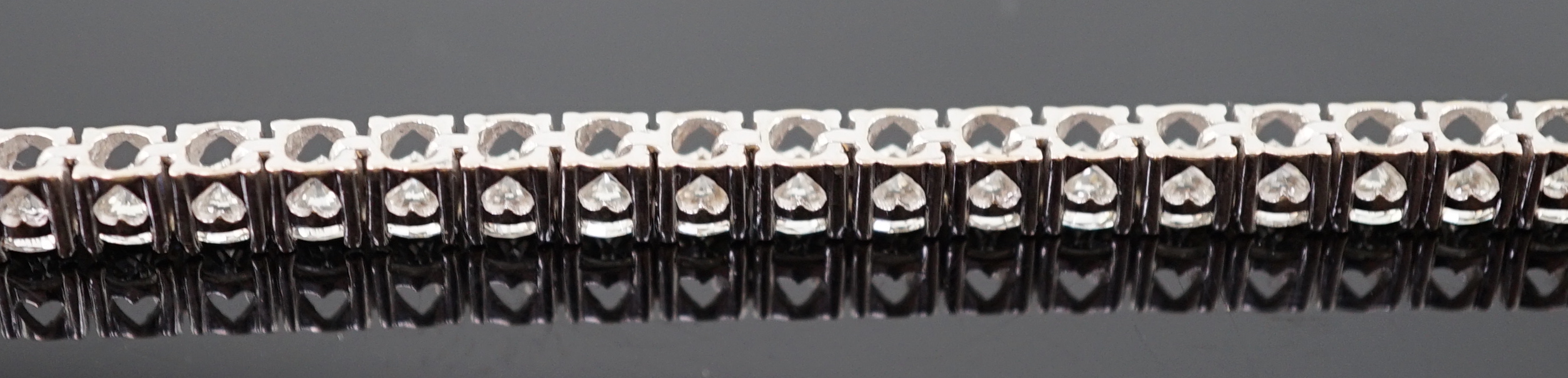 An 18k white gold and diamond line bracelet
